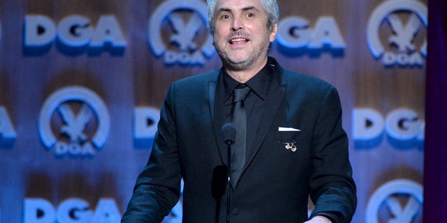CENTURY CITY, CA - JANUARY 25: Director Alfonso Cuaron accepts the Outstanding Directorial Achievement in Feature Film for 2013 award for ÂGravity onstage at the 66th Annual Directors Guild Of America Awards held at the Hyatt Regency Century Plaza on January 25, 2014 in Century City, California. (Photo by Alberto E. Rodriguez/Getty Images for DGA)