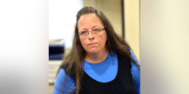 Rowan County Clerk Kim Davis listens to a customer following her office's refusal to issue marriage licenses at the Rowan County Courthouse in Morehead, Ky., Tuesday, Sept. 1, 2015. Although her appeal to the U.S. Supreme Court was denied, Davis still refuses to issue marriage licenses. (AP Photo/Timothy D. Easley)