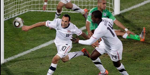 United States' Landon Donovan, front left, celebrates after scoring a goal with fellow team members United States' Clint Dempsey, back left, and United States' Edson Buddle, front right, during the World Cup group C soccer match between the United States and Algeria at the Loftus Versfeld Stadium in Pretoria, South Africa, Wednesday, June 23, 2010.  (AP Photo/Michael Sohn)