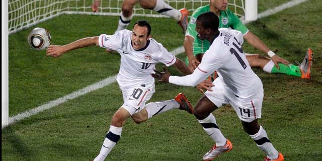 United States' Landon Donovan, front left, celebrates after scoring a goal with fellow team members United States' Clint Dempsey, back left, and United States' Edson Buddle, front right, during the World Cup group C soccer match between the United States and Algeria at the Loftus Versfeld Stadium in Pretoria, South Africa, Wednesday, June 23, 2010. (AP Photo/Michael Sohn)