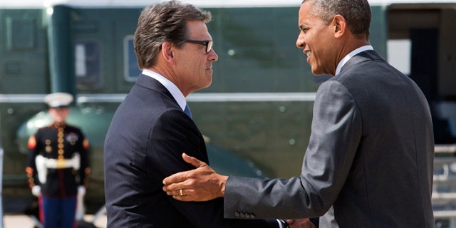 President Barack Obama, right, and Texas Gov. Rick Perry shake hands as Obama arrives in Dallas where they will attend a meeting about the border and immigration together, Wednesday, July 9, 2014. (AP Photo/Jacquelyn Martin)