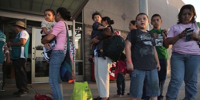MCALLEN, TX - JULY 25:  Central American immigrants just released from U.S. Border Patrol detention wait at the Greyhound bus station for their continued journey to various U.S. destinations on July 25, 2014 in McAllen, Texas. (Photo by John Moore/Getty Images)
