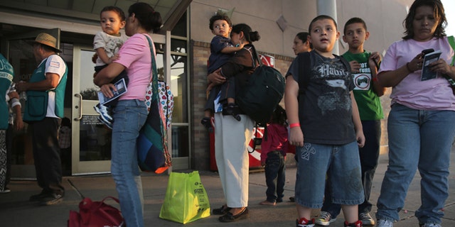 MCALLEN, TX - JULY 25: Central American immigrants just released from U.S. Border Patrol detention wait at the Greyhound bus station for their continued journey to various U.S. destinations on July 25, 2014 in McAllen, Texas. (Photo by John Moore/Getty Images)