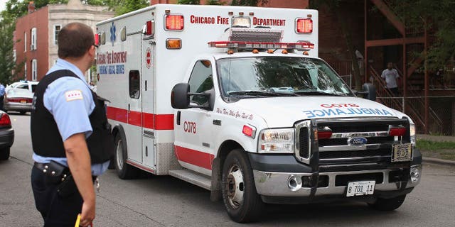 CHICAGO, IL - JULY 06: An ambulance leaves a crime scene where seven people were shot on July 6, 2013 in Chicago, Illinois. Two days earlier and half of a block away Steve Mabins, 21, was shot and killed on his way to an Independence Day party. More than 60 people have been shot in Chicago since Wednesday, at least nine fatally. (Photo by Scott Olson/Getty Images)