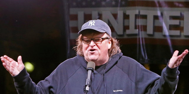 In this Thursday, Jan. 19, 2017, filmmaker Michael Moore speaks to thousands of people at an anti-Trump rally and protest in front of the Trump International Hotel in New York.