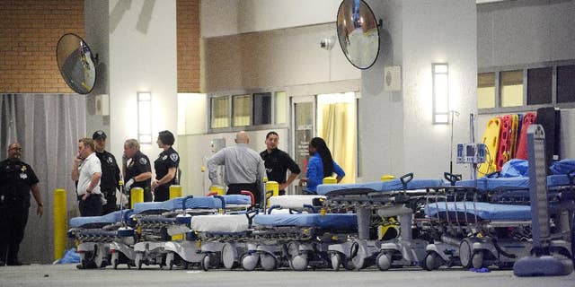 FILE - In this June 12, 2016, file photo,emergency personnel wait with stretchers at the emergency entrance to Orlando Regional Medical Center hospital for the arrival of patients from the scene of a fatal shooting at Pulse Orlando nightclub in Orlando, Fla. Radical Islamic militancy that has sustained itself for decades overseas has inspired a series of attacks on U.S. soil in the last year and a half. The culprits typically have no ties to foreign terrorist organizations, no explicit directions from overseas and no formal training, unlike the operatives of 9/11. Instead, they’ve blended into American society and skated beneath the radar of federal investigators grappling with a frenetic threat landscape and hundreds of investigations across the country. (AP Photo/Phelan M. Ebenhack, file)