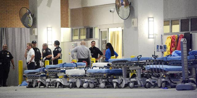FILE - In this June 12, 2016, file photo,emergency personnel wait with stretchers at the emergency entrance to Orlando Regional Medical Center hospital for the arrival of patients from the scene of a fatal shooting at Pulse Orlando nightclub in Orlando, Fla. Radical Islamic militancy that has sustained itself for decades overseas has inspired a series of attacks on U.S. soil in the last year and a half. The culprits typically have no ties to foreign terrorist organizations, no explicit directions from overseas and no formal training, unlike the operatives of 9/11. Instead, they’ve blended into American society and skated beneath the radar of federal investigators grappling with a frenetic threat landscape and hundreds of investigations across the country. (AP Photo/Phelan M. Ebenhack, file)