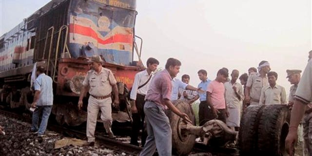 July 07: Volunteers help look for survivors and clear debris after a deadly collision between a train and a bus left 35 dead.
