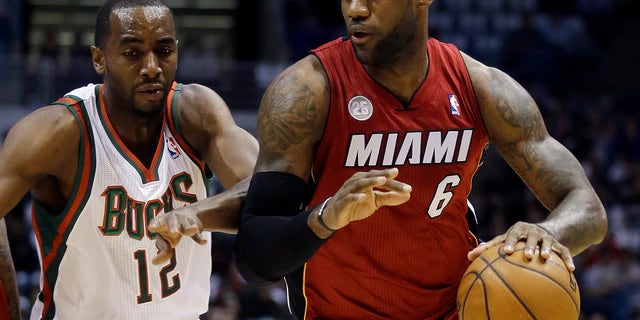 Miami Heat's LeBron James (6) drives past Milwaukee Bucks' Luc Richard Mbah a Moute during the first half of Game 3 in their first-round NBA basketball playoff series on Thursday, April 25, 2013, in Milwaukee. (AP Photo/Morry Gash)