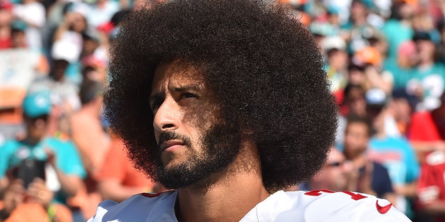 Nov. 27, 2016: Colin Kaepernick looks on before a game against the Miami Dolphins at Hard Rock Stadium.