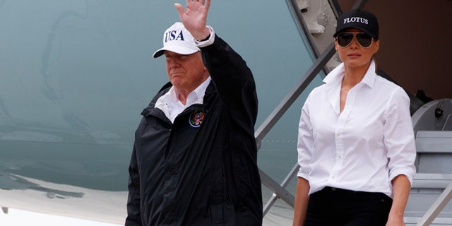 President Donald Trump, accompanied by first lady Melania Trump, waves as they arrive on Air Force One at Corpus Christi International Airport in Corpus Christi, Texas, Tuesday, Aug. 29, 2017, for briefings on Hurricane Harvey relief efforts. (AP Photo/Evan Vucci)