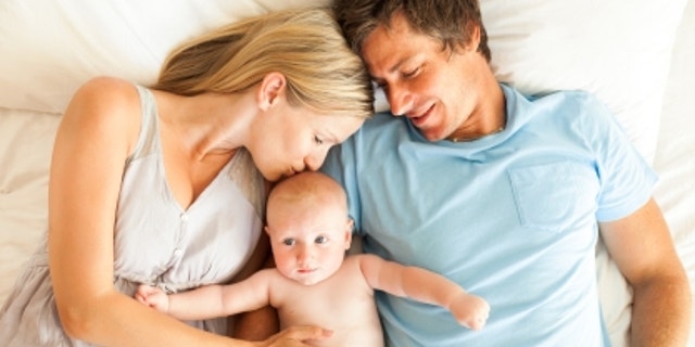 The AAP recommends that infants sleep in the same room as parents for at least the first six months of life — but in a separate bed.