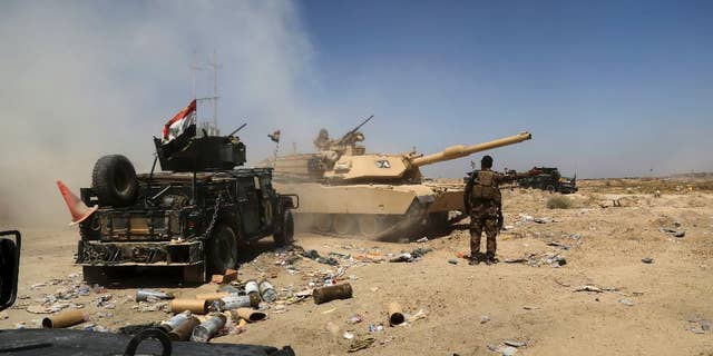 Major drug makers helped fund Iraqi militias that attacked U.S. troops, a lawsuit alleged Tuesday. Pictured: Iraqi military forces engage in operations in an undated photo.