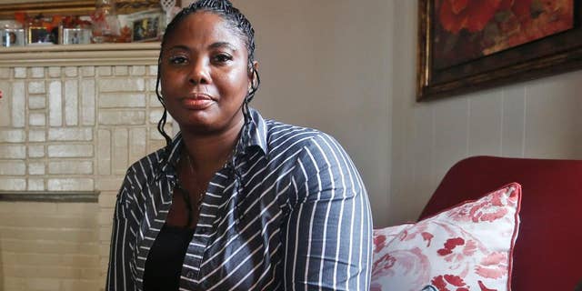 FILE- In this Nov. 12, 2015, file photo, Gwendolyn Smalls poses for a photo in her home in Richmond, Va. Smalls' brother, Linwood R. Lambert Jr., died in police custody in May of 2013 after being repeatedly stunned by South Boston police. U.S. Attorney John Fishwick Jr. said Thursday, Sept. 22, 2016, that he will not pursue federal criminal civil rights charges against three Virginia police officers who used stun guns multiple times onLambert Jr. before his death. The officers face a $25 million civil lawsuit filed by Gwendolyn Smalls. A trial was originally set for early 2017, but he officers’ attorneys have asked for it to be pushed back until later in the year. (AP Photo/Steve Helber, File)