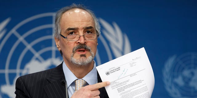 Syrian Ambassador to the United Nations, Bashar Ja'afari, points to a document during a press conference during the Syrian peace talks in Montreux, Switzerland, Wednesday, Jan. 22, 2014. U.N. Secretary-General Ban Ki-moon opened the meeting saying that the peace talks will face "formidable" challenges for Syria. Ban called on the Syrian government and the opposition trying to overthrow it to negotiate in good faith.(AP Photo/KEYSTONE/Salvatore Di Nolfi)