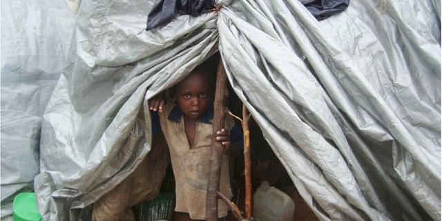 July 31: A young boy from southern Somalia takes cover in a makeshift shelter in Mogadishu.