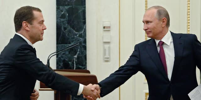 Russian President Vladimir Putin, right, shaking hands with Prime Minister Dmitry Medvedev last September.