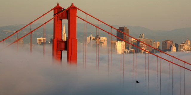 FILE: April 18, 2009: The skyline of San Francisco and the Golden Gate Bridge appear above the evening fog in Sausalito, Calif.