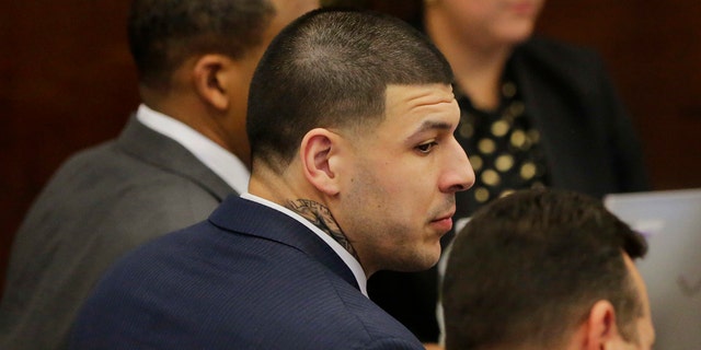 Former New England Patriots tight end Aaron Hernandez sits with his attorneys Jose Baez, right, and Ronald Sullivan, left, at the opening of the fist day of his double murder trial at Suffolk Superior Court on Wednesday, March 1, 2017, in Boston. Hernandez is standing trial for the July 2012 killings of Daniel de Abreu and Safiro Furtado who he encountered in a Boston nightclub. He is already serving a life sentence in the 2013 killing of semi-professional football player Odin Lloyd. (AP Photo/Stephan Savoia, Pool)