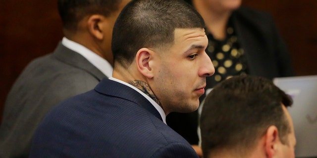 Former New England Patriots tight end Aaron Hernandez sits with his attorneys Jose Baez, right, and Ronald Sullivan, left, at the opening of the fist day of his double murder trial at Suffolk Superior Court on Wednesday, March 1, 2017, in Boston. Hernandez is standing trial for the July 2012 killings of Daniel de Abreu and Safiro Furtado who he encountered in a Boston nightclub. He is already serving a life sentence in the 2013 killing of semi-professional football player Odin Lloyd. (AP Photo/Stephan Savoia, Pool)