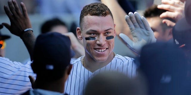 Yankees rookie Aaron Judge is greeted by his teammates in the dugout after hitting a two-run home run Monday.