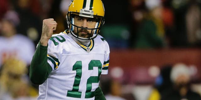 Green Bay Packers quarterback Aaron Rodgers (12) celebrates tight end Jared Cook's touchdown during the second half of an NFL football game against the Washington Redskins in Landover, Md., Sunday, Nov. 20, 2016. (AP Photo/Mark Tenally)