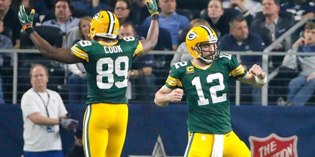 Green Bay Packers quarterback Aaron Rodgers (12) and Jared Cook (89) celebrate after a touchdown during the first half of an NFL divisional playoff football game against the Dallas Cowboys Sunday, Jan. 15, 2017, in Arlington, Texas. (AP Photo/Tony Gutierrez)