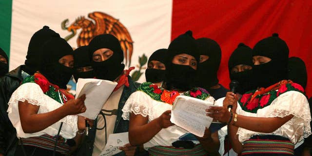 FILE - In this July 24, 2007 file photo, masked female members of the Zapatista National Liberation Army (EZLN), sing during a meeting with supporters in Morelia, Chiapas state, Mexico, after the rebels pledged to move away from armed struggle and toward politics more than a decade after a short-lived revolt for Indian rights and socialism. The EZLN announced on Friday, Oct. 14, 2016 its decision to nominate an indigenous woman as their independent candidate for Mexico's presidency, ahead of 2018 elections. (AP Photo/Moyses Zuniga, File)