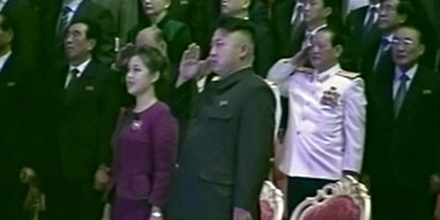 In this Tuesday, Jan. 1, 2013 image made from video, North Korean leader Kim Jong Un, center right, salutes as he and his wife Ri Sol Ju, center left, attend a New Year's concert in Pyongyang, North Korea.