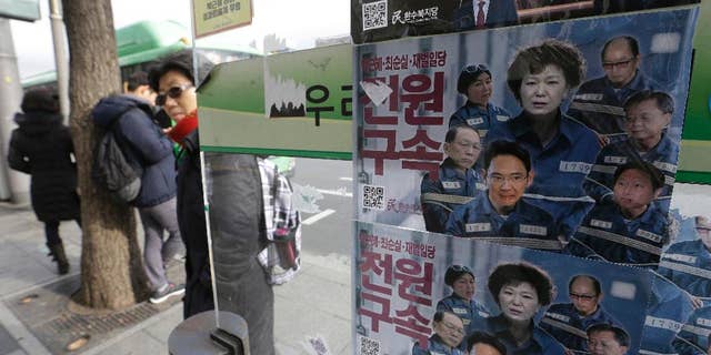 FILE-In this Dec. 19, 2016, file photo, posters showing portraits of impeached South Korea's President Park Geun-hye, center, her aides and business men are displayed at a bus station in Seoul, South Korea. Prosecutors will not be allowed to search South Korea's presidential compound as part of their investigation of the massive corruption scandal that toppled Park from power, the president's office said Thursday, Feb. 2, 2017. The letter read "Arrest." (AP Photo/Ahn Young-joon, File)