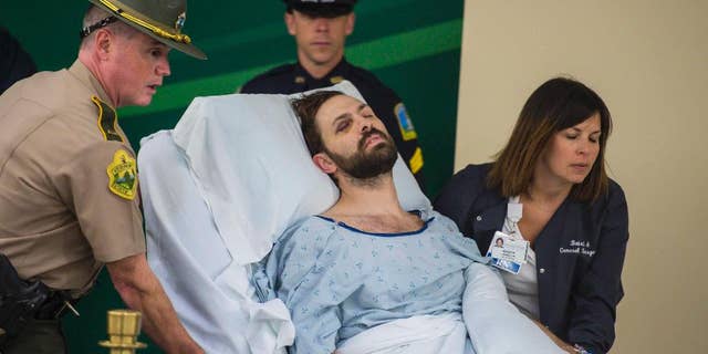 FILE - In this Oct. 14, 2016 file photo, Steven Bourgoin is brought in to be arraigned in a makeshift courtroom at the University of Vermont Medical Center on five counts of second-degree murder in Burlington, Vt. The deaths of five teenagers in a fiery car wreck that police say was caused by Bourgoin, a wrong-way driver, has been removed from the list of the state’s highway fatalities for last year and has been reclassified as murder. (Glenn Russell/The Burlington Free Press via AP, Pool)