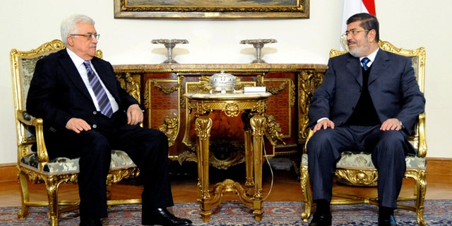 Jan. 9, 2013: In this image released by the Egyptian Presidency, Egyptian President Mohammed Morsi, right, meets with Palestinian President Mahmoud Abbas at the Presidential Palace in Cairo, Egypt.