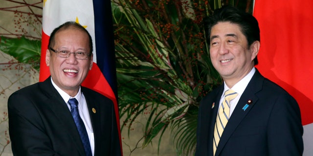 Japanese Prime Minister Shinzo Abe, right, shakes hands with Philippine President Benigno Aquino III prior to their working lunch at Abe's official residence in Tokyo, Friday, Dec. 13, 2013. Aquino is in Tokyo to attend meetings between Japanese and ASEAN leaders. (AP Photo/Koji Sasahara, Pool)
