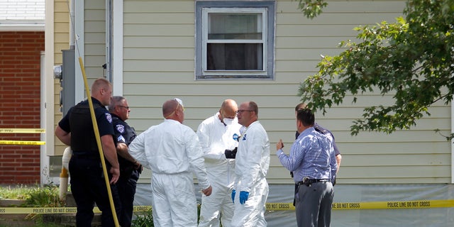 Authorities execute a search warrant on a home on Tuesday in Ashland, Ohio.