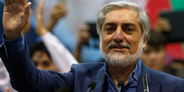 July 8: Afghan presidential candidate Abdullah Abdullah waves to his supporters during a gathering in Kabul. Abdullah told thousands of supporters on Tuesday he was the winner of last month's run-off election.