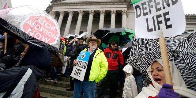 Anti-abortion demonstrators take part in a rally, Tuesday, Jan. 19, 2016, at the Capitol in Olympia, Wash. (AP Photo/Ted S. Warren)