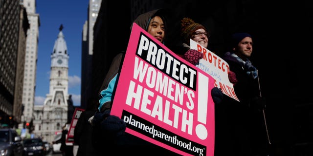 Abortion rights advocates Grace Fried, center, Claire Roden and David Tuke demonstrate in view of Philadelphia City Hall Friday, Jan. 21, 2011 on the eve of the anniversary of the 1973 Roe v. Wade Supreme Court decision that legalized abortion. (AP)