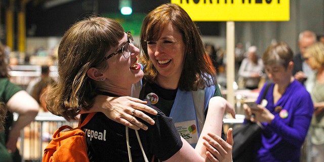 People from the"Yes" campaign react as the results of the votes begin to come in, after the Irish referendum on the 8th Amendment of the Irish Constitution at the RDS count centre, in Dublin, Ireland, Saturday .
