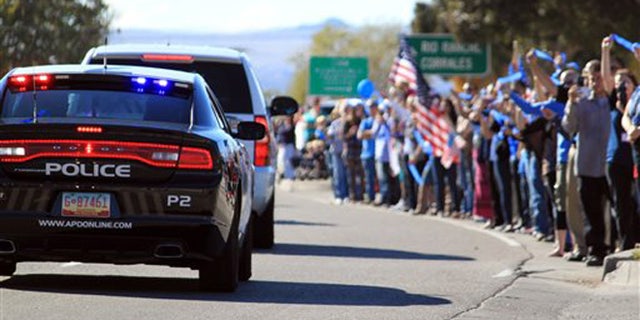 Nov. 3, 2015: Thousands of people line the route for slain Albuquerque Police Officer Daniel Webster's funeral procession in Albuquerque, N.M.