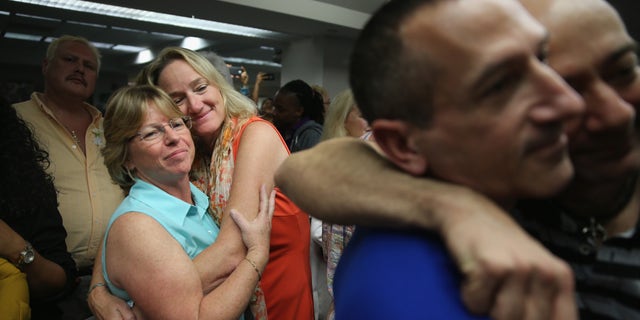 FORT LAUDERDALE, FL - JANUARY 06: Couples embrace as they attend a wedding ceremony at the Broward County Courthouse on January 6, 2015 in Fort Lauderdale, Florida. Gay marriage is now legal statewide after the courts ruled that the ban on gay marriage is unconstitutional and the Supreme Court declined to intervene. (Photo by Joe Raedle/Getty Images)