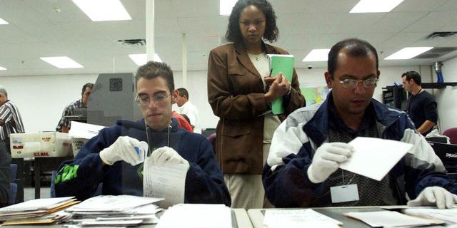 Temporary election employees sort absentee ballots in a Miami-Dade County elections office, Doral, Florida. (AP)