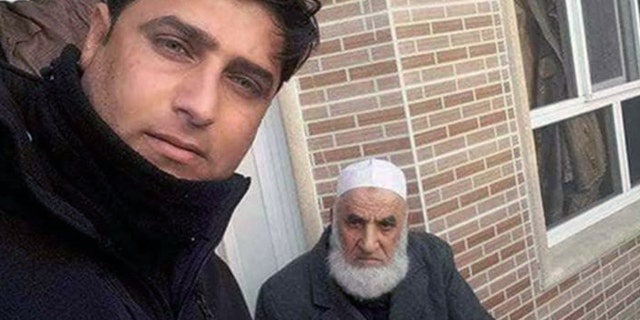 A man purported to be an Iraqi security forces officer poses with a man believed to be ISIS executioner Abu Omer after the latter's capture in Mosul last week.