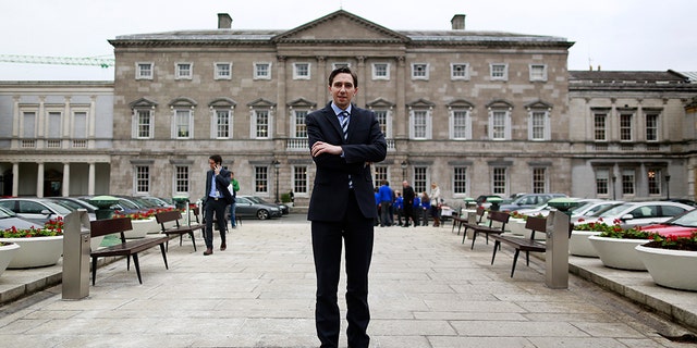 Ireland's Minister of State for Finance Simon Harris poses for a picture in front of Leinster House in Dublin, March 2015.