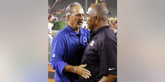 Indianapolis Colts head coach Chuck Pagano, left, meets with Cincinnati Bengals head coach Marvin Lewis after the Bengals defeated the Colts 35-7 in an NFL preseason football game, Thursday, Aug. 28, 2014, in Cincinnati. (AP Photo/Tom Uhlman)