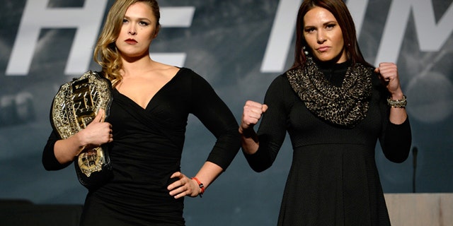 LAS VEGAS, NEVADA - NOVEMBER 17: UFC women's bantamweight champion Ronda Rousey (L) and challenger Cat Zingano pose for the media during the UFC Time Is Now press conference at The Smith Center for the Performing Arts on November 17, 2014 in Las Vegas, Nevada. (Photo by Jeff Bottari/Zuffa LLC/Zuffa LLC via Getty Images)