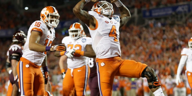 Clemson quarterback Deshaun Watson (4) celebrates his touchdown, during the second half of the Atlantic Coast Conference championship NCAA college football game against Virginia Tech, Saturday, Dec. 3, 2016, in Orlando, Fla. (AP Photo/Willie J. Allen Jr.)