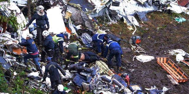 Rescue workers search for survivors outside Medellin, Colombia, Tuesday, Nov. 29, 2016.