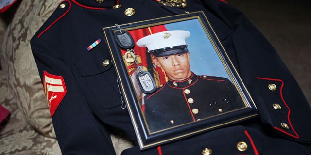 Jan. 15, 2012: Itzcoatl Ocampo's dress uniform, government military photo, dog tags and a religious medallion that went to war with him lie on display at Ocampo's home in Yorba Linda, Calif.