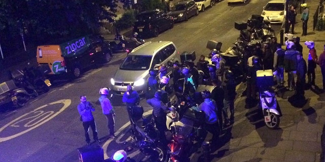 Authorities search the scene of an acid attack in London on July 13.