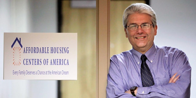 In this photo taken, March 12, 2010, in Chicago, Michael Shea, Executive Director of Affordable Housing Centers of America, formally known as ACORN Housing poses next to the organization's new sign. (AP)